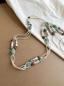 Detail of bohemian acrylic geometric beads and woven cord on a vintage style waist chain