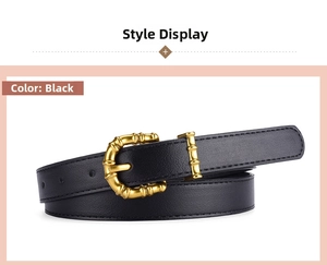 Detail of black leather belt featuring a bamboo texture golden buckle and D-shape ring