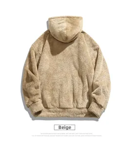 Macro shot of soft beige polar fleece hoodie texture with loose drop-shoulder design