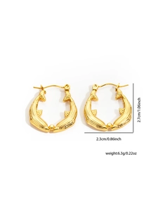 Detailed view of golden fish-shaped titanium steel earrings with high-polish texture