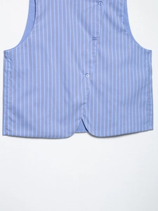 Detail view of vertical striped vest hem with buttons and premium woven fabric