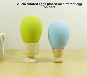 Detail of 2pcs 8cm light green and blue decorative eggs on minimalist wooden holders