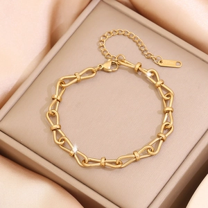 Golden U-shaped pig nose link bracelet displayed on a premium champagne jewelry box
