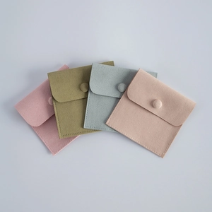 Detailed view of microfiber jewelry pouches in pink, green, blue and beige colors