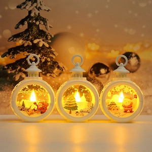 Three LED Christmas lanterns featuring Santa and snow patterns with warm festive lighting