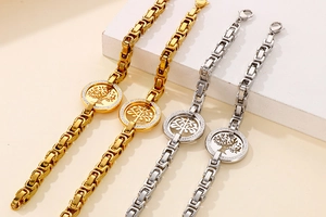 Close-up of gold and silver Tree of Life bracelets with cubic zirconia and steel chains