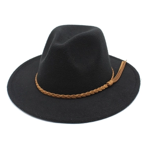 Detail of black wool fedora hat with a brown braided leather band and tassel fringe