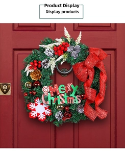Detail of pine needle wreath with red bow and Merry Christmas sign on a wooden door