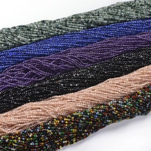 Detailed close-up of multi-colored natural tiger eye round beads in sorted parallel rows