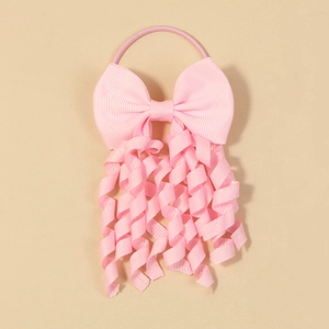 Detailed shot of pink grosgrain ribbon bow with spiral streamers and elastic hair tie