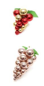 Detail of metallic Christmas grape cluster ornaments in red gold and rose gold finishes