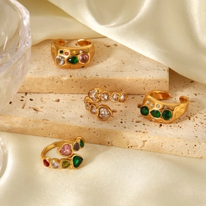 Detail of 18k gold plated stainless steel rings with colorful heart-shaped zircons