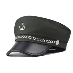 Detail of anchor badge and silver chain on an olive green nautical military cap