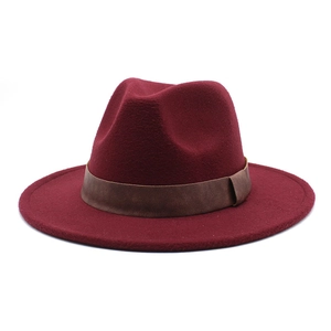 Detail of burgundy wool fedora with dark brown leather decorative band and wide brim