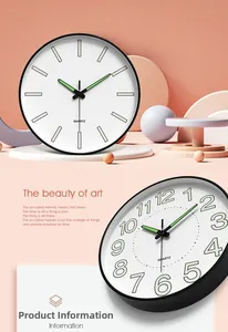 Close-up of modern quartz wall clock with luminous numbers and minimalist markers