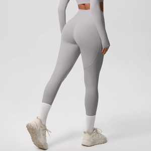 Close-up of curved seam stitching and elastic fabric on high-waist gray yoga leggings