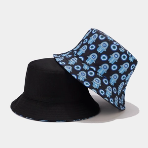 Reversible vintage bucket hat with evil eye pattern and solid black canvas design
