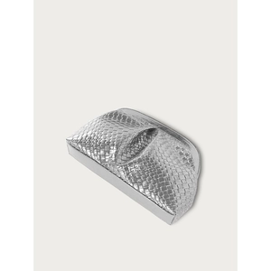 Macro detail of silver woven texture and metallic finish on the women's clutch bag
