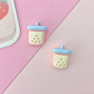 Detail of miniature resin milk tea cups in pink and blue for DIY craft decoration