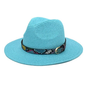 Bright blue woven straw fedora hat with patterned band and gold buckle for summer sun protection