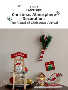 Detail of wooden Santa and reindeer Christmas ornaments for festive tree decoration