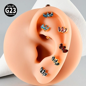 Detail view of G23 titanium labret studs with marquise zircons on silicone ear model