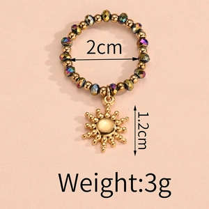Detail view of elastic bead ring with sun pendant showing 2cm diameter and 3g weight