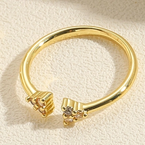 Close-up of golden adjustable open ring featuring six small inlaid zircon stones