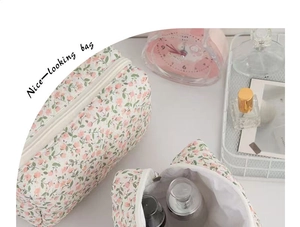 Macro view of pink floral cosmetic bag set showing zipper detail and spacious white interior