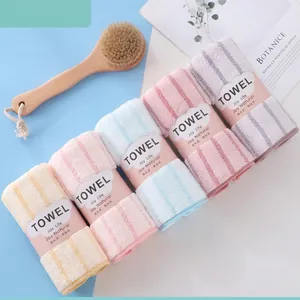 Absorbent coral fleece towels in soft striped pastel colors with elegant paper bands