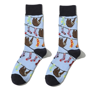Detail of light blue crew socks featuring funny cartoon sloth and hanging laundry prints
