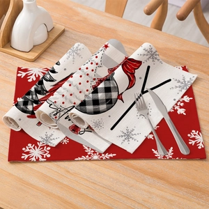 Christmas placemat set with snowflake and festive prints on a rustic wooden table