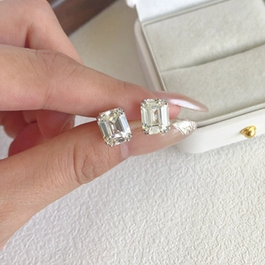 Macro shot of square-cut zircon stud earrings in a classic four-prong silver setting