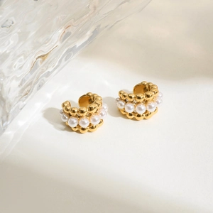 Detail of 18K gold-plated ear cuffs with triple rows featuring elegant white pearls