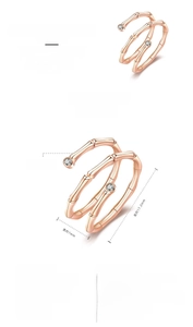 Detail of rose gold bamboo style open ring with two diamonds and adjustable band