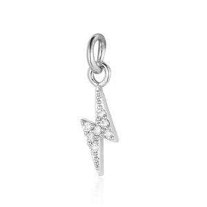 Macro shot of silver lightning bolt pendant with sparkling zircon inlays and shiny finish