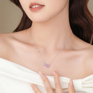 Elegant S925 sterling silver butterfly and flower necklace with pink zirconia on a model