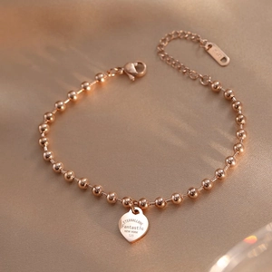 Rose gold beaded heart charm bracelet with ETERNALLOVE engraving and lobster clasp