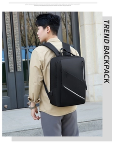 Man wearing the black business backpack with external USB charging port and side zip detail