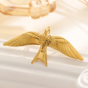 Macro shot of detailed golden bird wing texture on a high-quality stainless steel jewelry piece