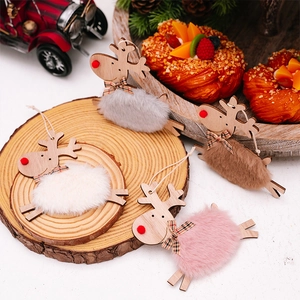 Detail of wooden reindeer ornaments with faux fur textures and festive red plaid bows