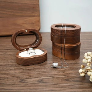Macro shot of oval walnut wood jewelry box featuring magnetic closure and soft lining