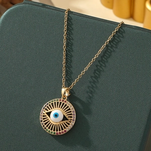 Macro detail of gold evil eye necklace with colorful crystals on green leather
