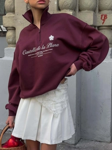 Retro burgundy half-zip sweatshirt with white text print and a high neck collar