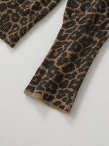 Detailed close-up of leopard print knit cardigan sleeve with ribbed cuff detail