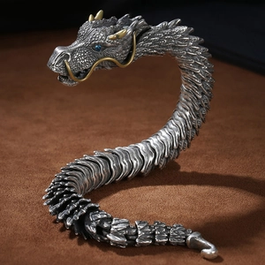 Retro dragon bone link bracelet in silver and gold finish with blue crystal eyes