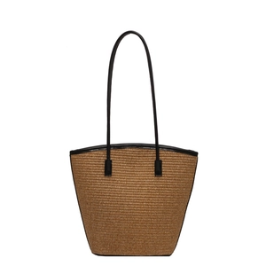 Brown striped woven straw tote bag with black long handles for beach vacations
