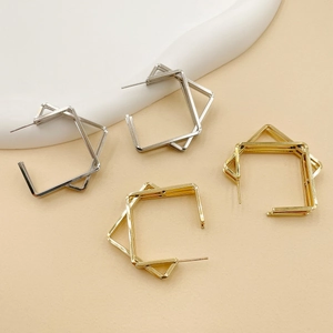 Close-up of elegant double-layered geometric square stud earrings in gold and silver
