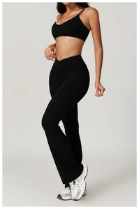 Detail of high-waist yoga pants with V-cross waistband and flared leg silhouette