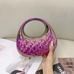Macro shot of iridescent purple holographic evening bag with diamond quilt and round handle